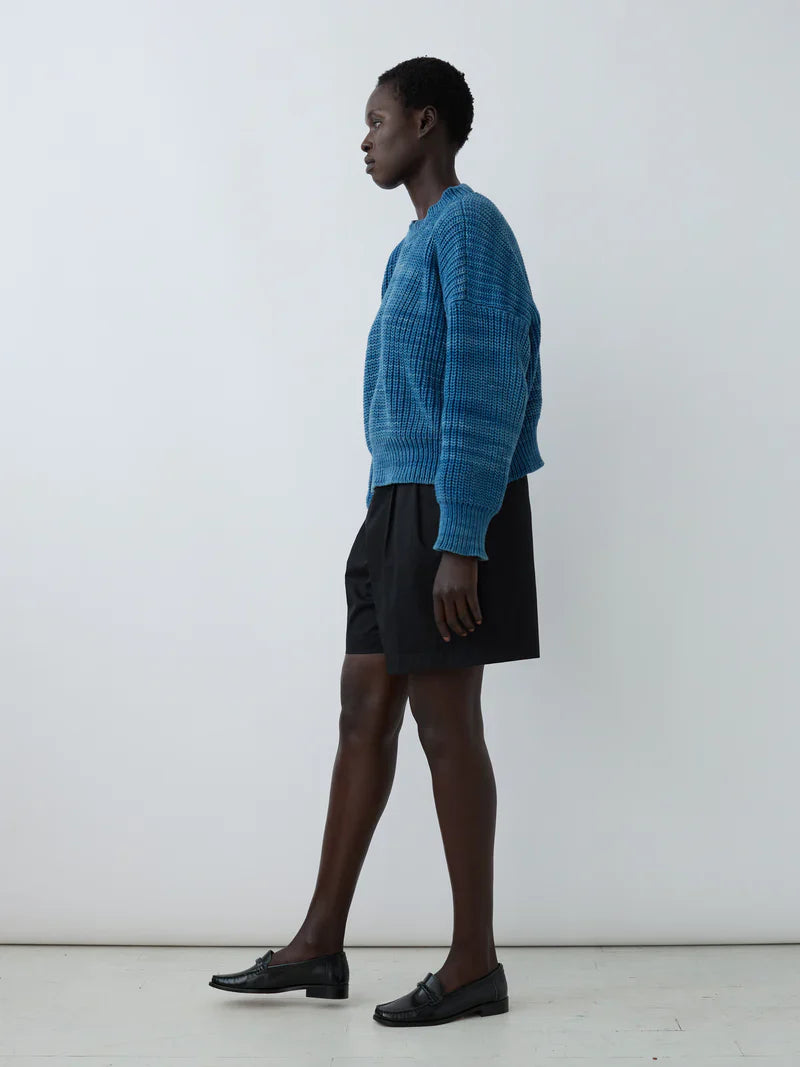 Model wearing Shaina Mote's Boy Short in Onyx and a blue sweater, showcasing relaxed Bermuda style.