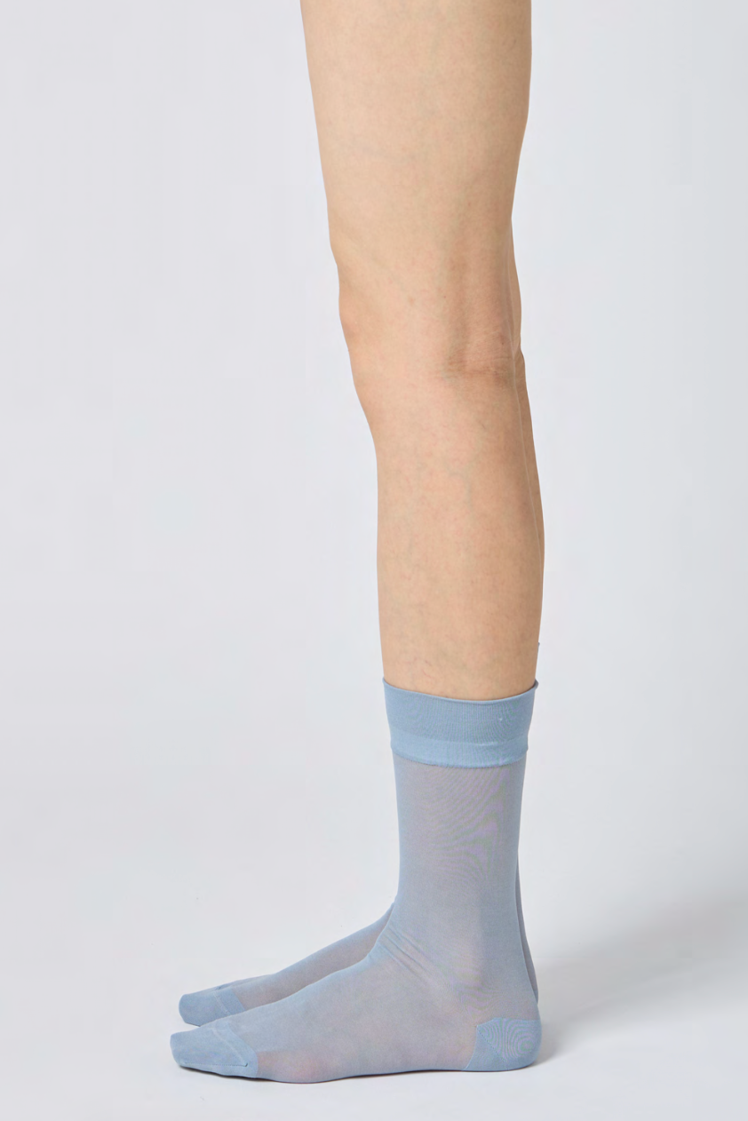 Light blue/grey socks on a white background