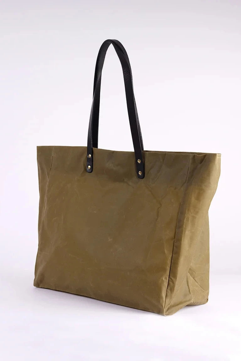 Tan tote bag with black handles on a white background